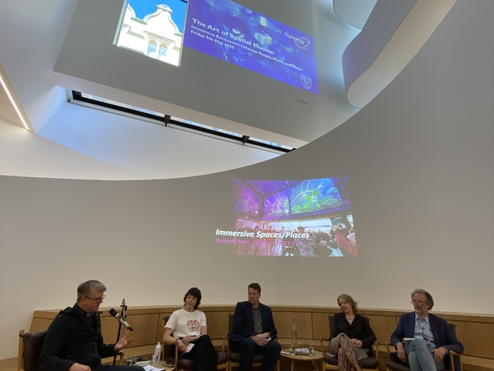 Event with people sitting chatting in chairs