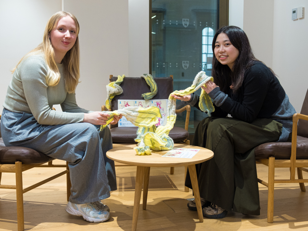 Two artists posing with their artwork