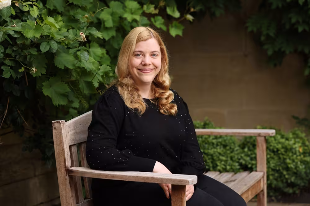 Woman with blonde hair sitting on chair