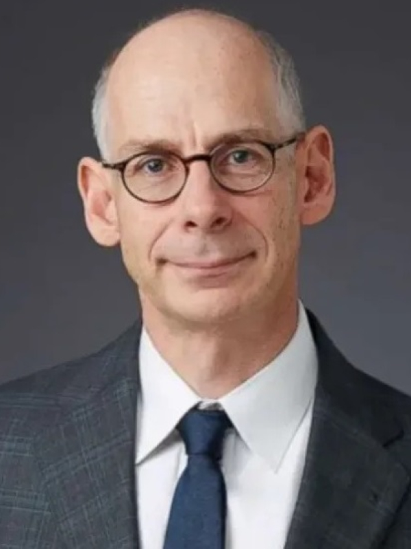 White male wearing suit and tie with glasses