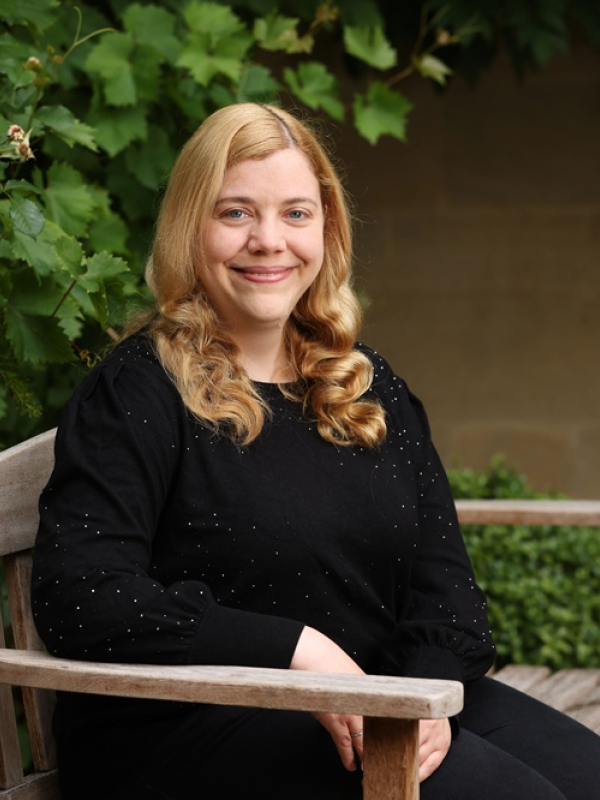 Woman with blonde hair sitting on chair