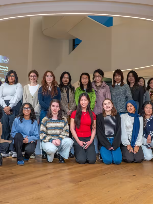 group of twenty women of all ages standing in modern building 