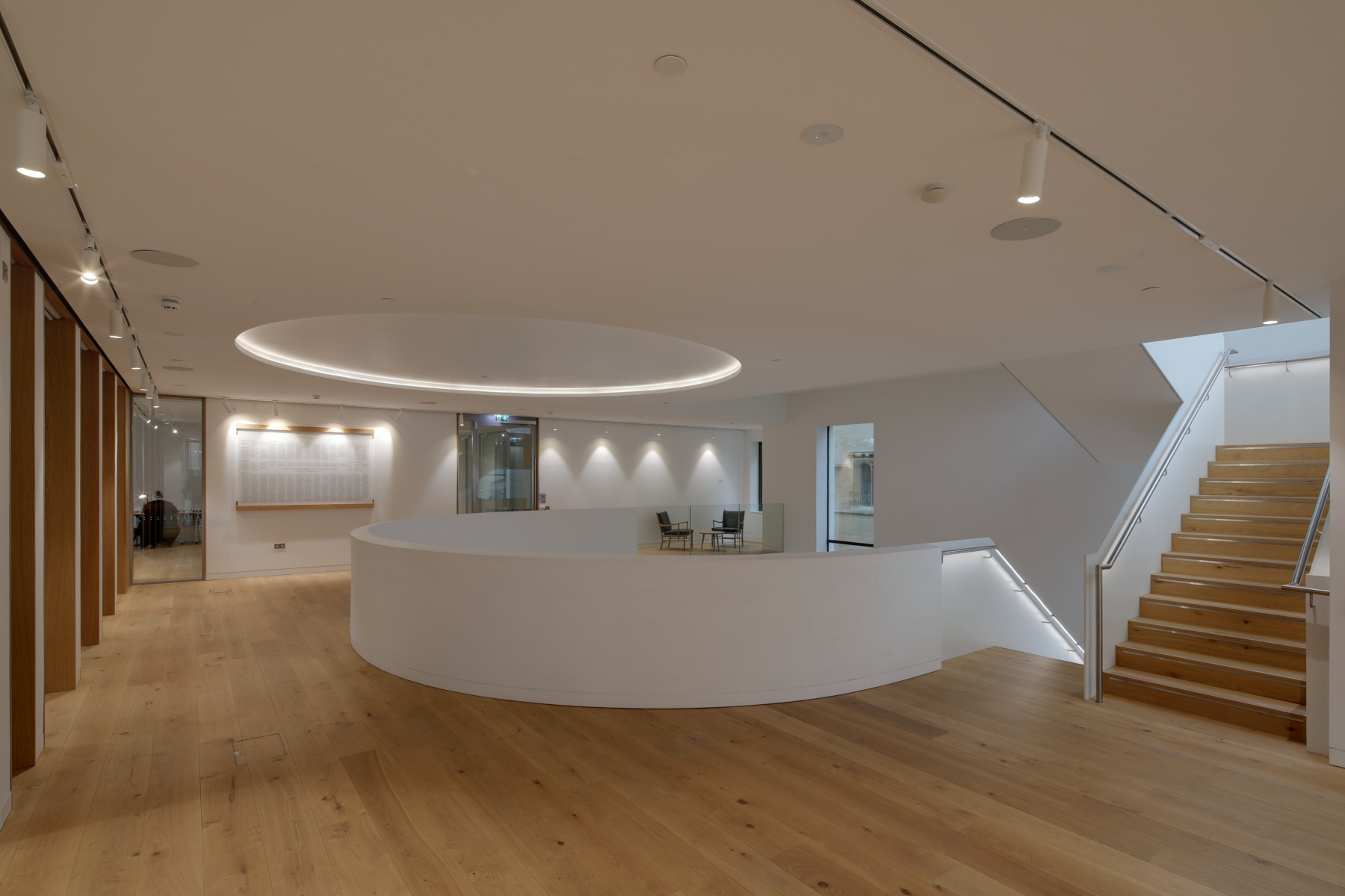 Open space with wood flooring and white walls